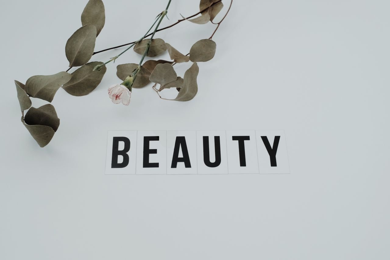 services-02 A minimalist image featuring an eucalyptus branch with the word 'BEAUTY' on a white background.